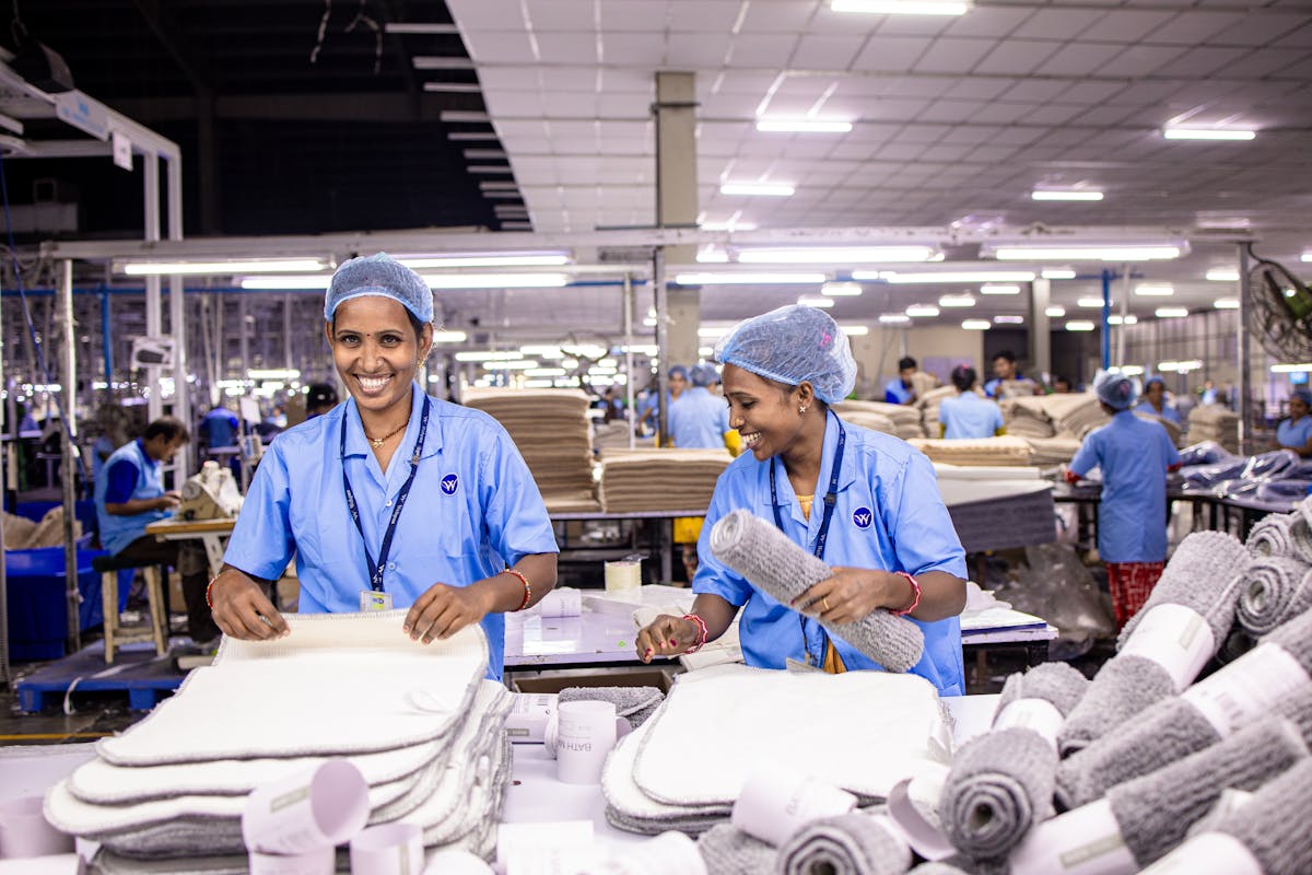 Contract workers wearing helmets at an industrial site